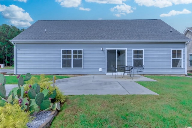 back of house featuring a lawn and a patio