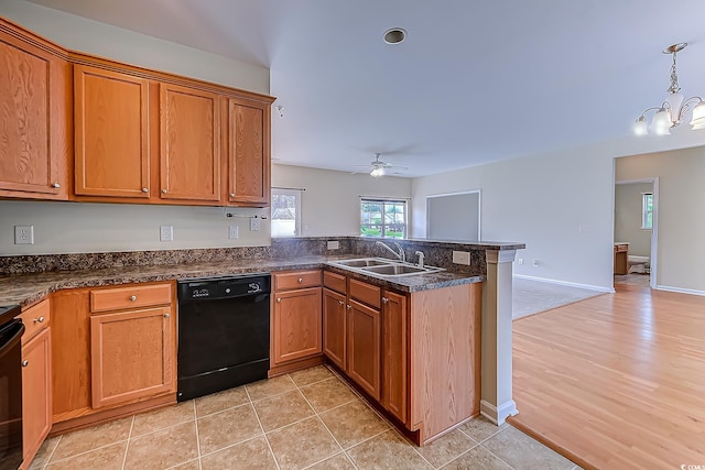 kitchen featuring light hardwood / wood-style floors, pendant lighting, sink, dishwasher, and kitchen peninsula