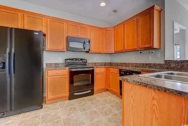 kitchen with black appliances and light tile patterned floors