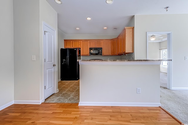 kitchen with light wood-type flooring, black appliances, and ceiling fan