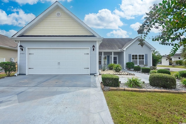 view of front of home with a front yard and a garage