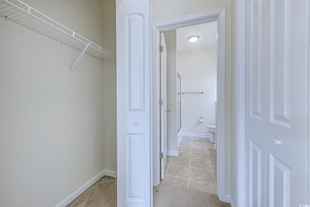 spacious closet featuring light tile patterned floors