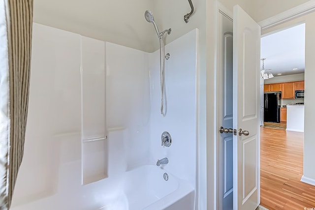 bathroom featuring shower / bathtub combination and hardwood / wood-style floors