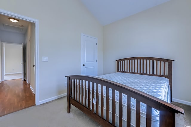 bedroom featuring lofted ceiling and carpet