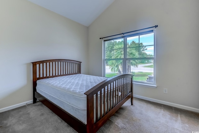 bedroom with high vaulted ceiling, multiple windows, and carpet floors