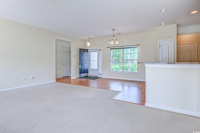 entryway featuring an inviting chandelier and light hardwood / wood-style flooring