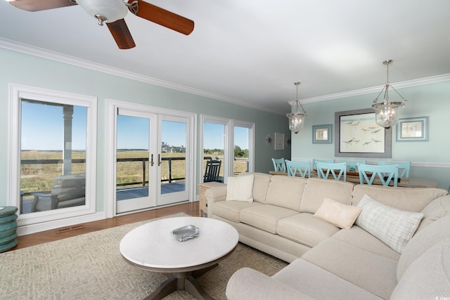 living room with crown molding, french doors, ceiling fan, and hardwood / wood-style flooring