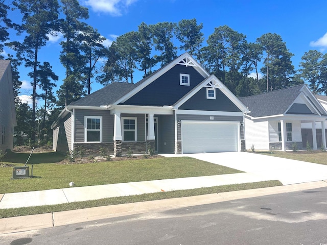 craftsman house with a garage and a front yard