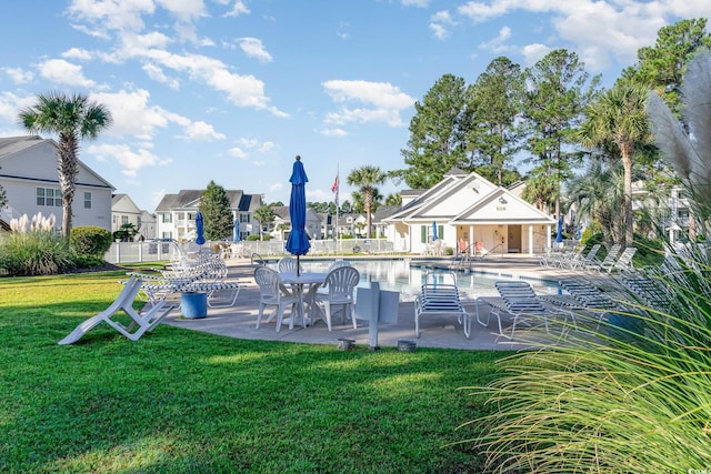 view of pool with a yard and a patio area