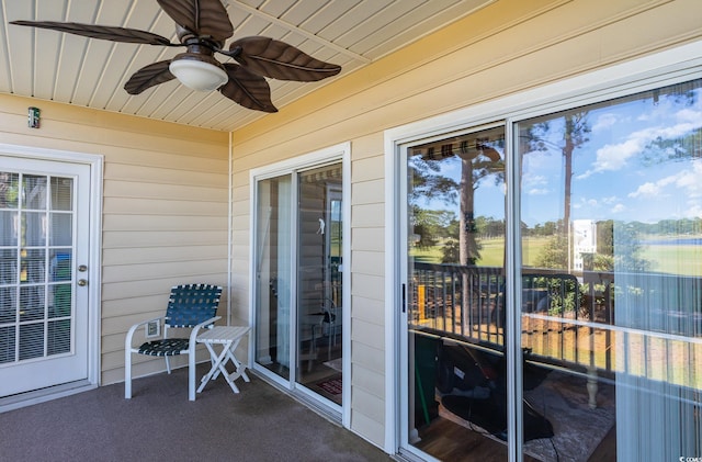 sunroom featuring ceiling fan