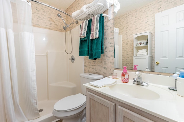 bathroom featuring a textured ceiling, vanity, toilet, and a shower with curtain