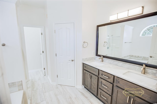 bathroom with vanity and a tub