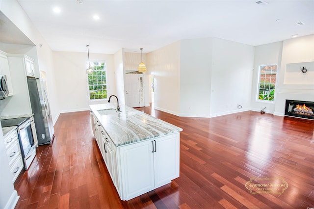 kitchen with white cabinets, a wealth of natural light, stainless steel appliances, and sink