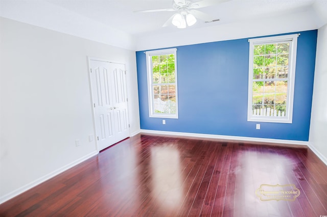 spare room with ceiling fan and dark hardwood / wood-style flooring