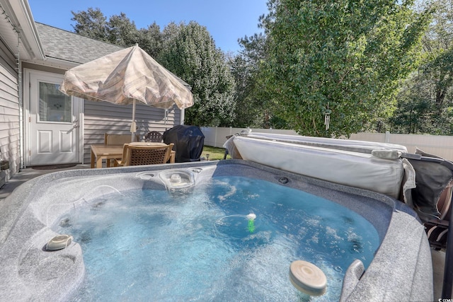 view of pool featuring a hot tub and grilling area