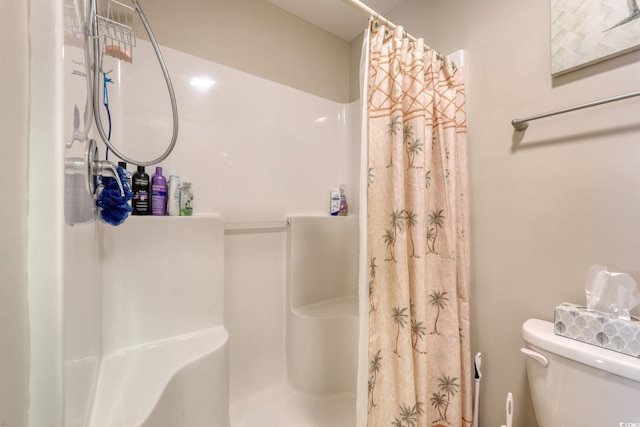 bathroom featuring toilet and walk in shower