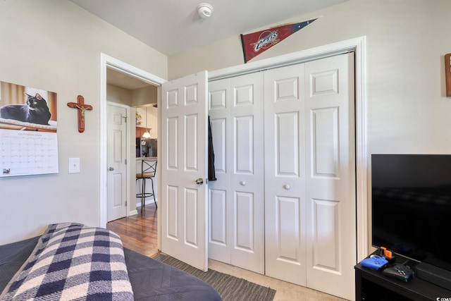 bedroom with wood-type flooring and a closet