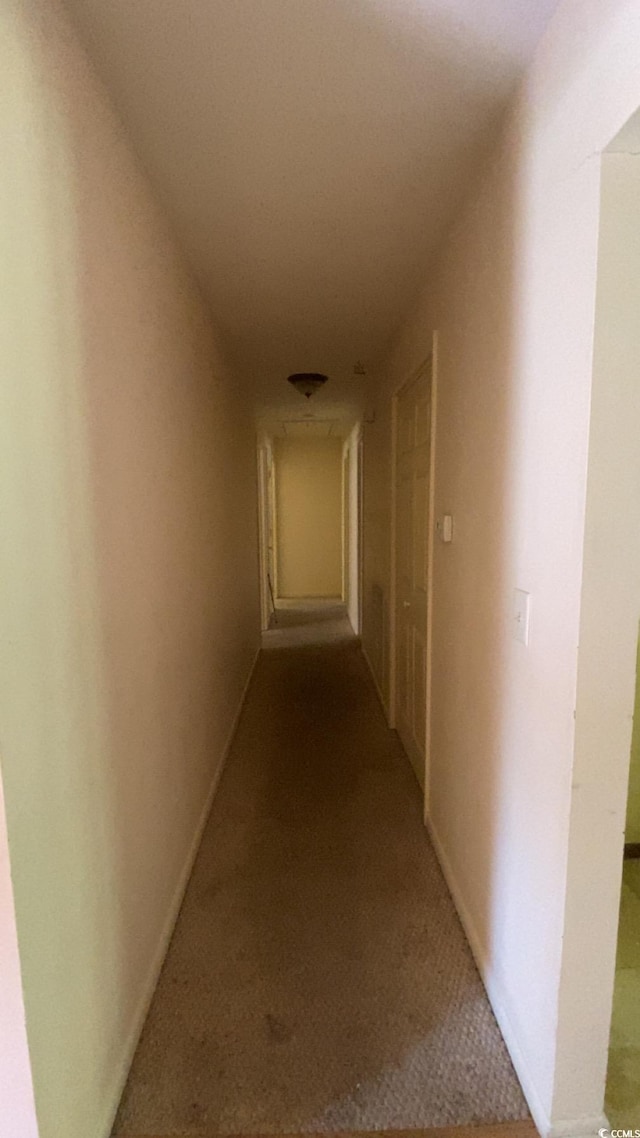 hallway featuring light colored carpet