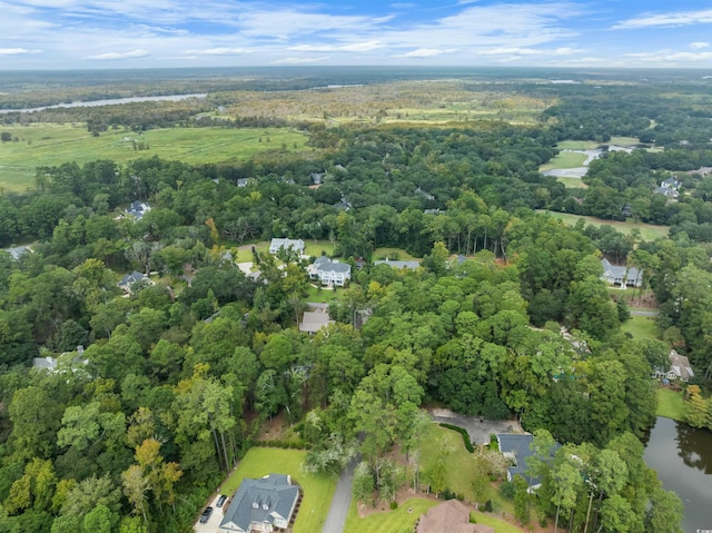 drone / aerial view featuring a water view and a view of trees