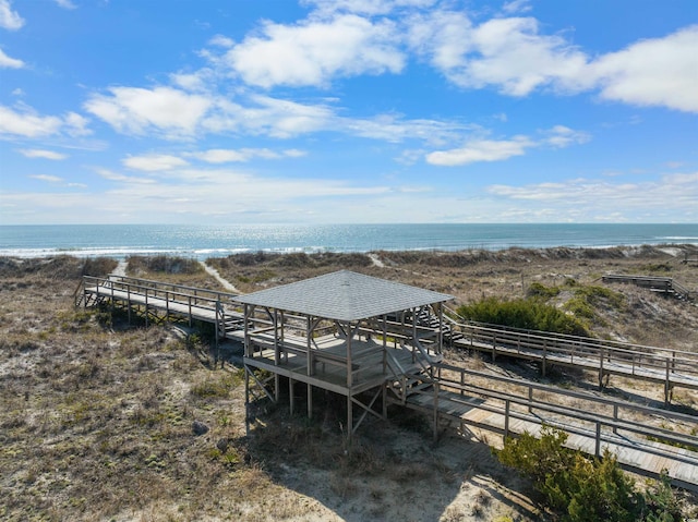 surrounding community featuring a view of the beach and a water view