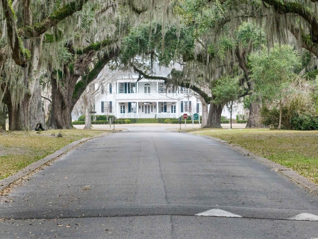view of road featuring traffic signs and curbs
