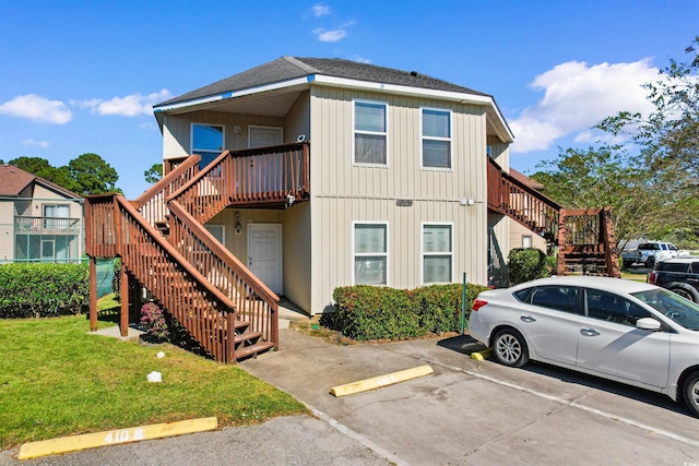 exterior space featuring a front yard and a wooden deck