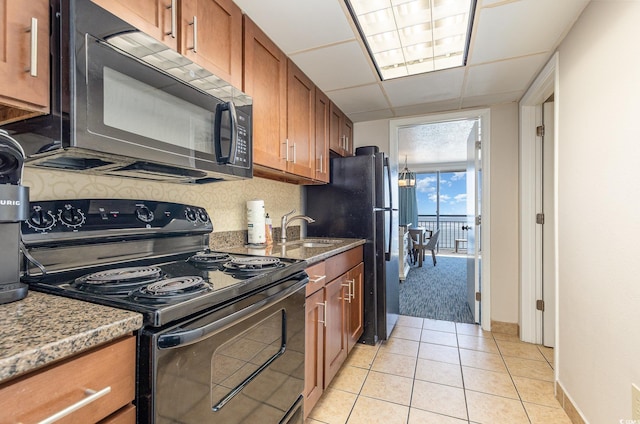 kitchen featuring light tile patterned flooring, a drop ceiling, stainless steel electric range oven, and sink