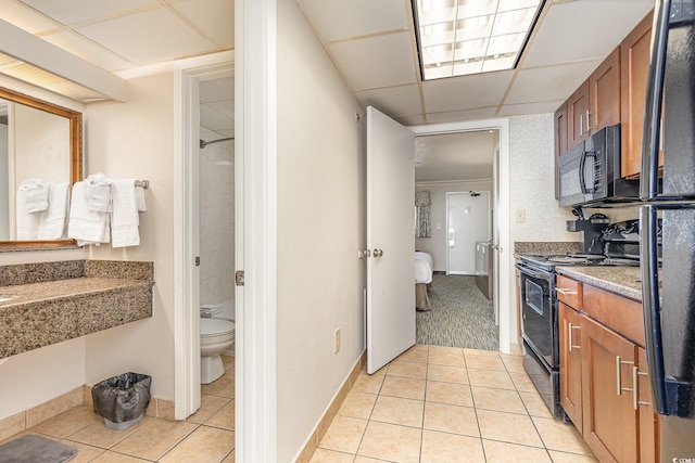 interior space featuring tile patterned flooring, toilet, and a shower