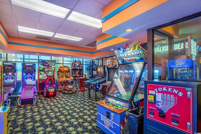 game room with carpet floors and a paneled ceiling