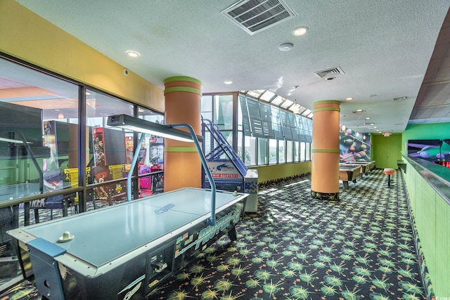 game room featuring carpet flooring and a textured ceiling