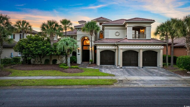 mediterranean / spanish-style home with a garage