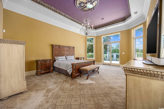 carpeted bedroom with visible vents, a chandelier, a tray ceiling, ornamental molding, and access to outside