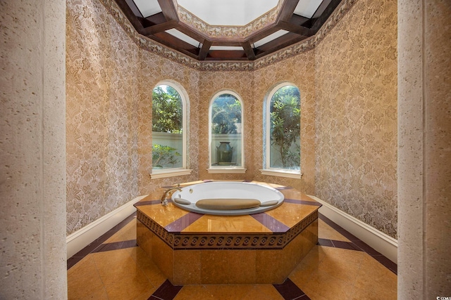 bathroom with wallpapered walls, a garden tub, and baseboards