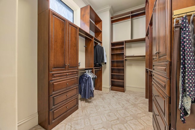 walk in closet featuring light colored carpet