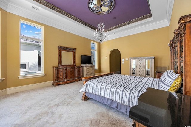 bedroom with carpet, visible vents, a tray ceiling, arched walkways, and a chandelier