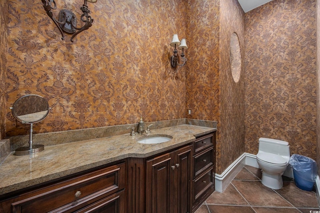 bathroom featuring toilet, vanity, and tile patterned flooring