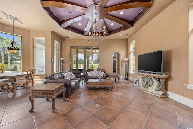 living room with beam ceiling, a notable chandelier, coffered ceiling, recessed lighting, and baseboards