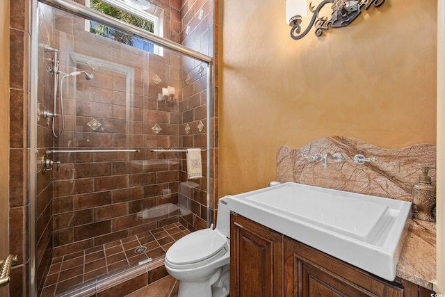 bathroom featuring vanity, toilet, and a stall shower