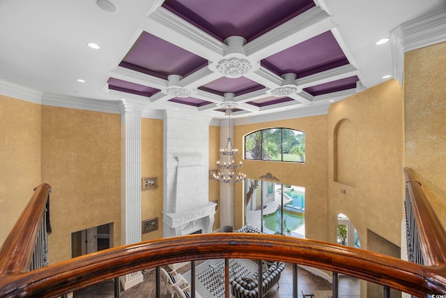 stairs featuring coffered ceiling, decorative columns, recessed lighting, ornamental molding, and a notable chandelier