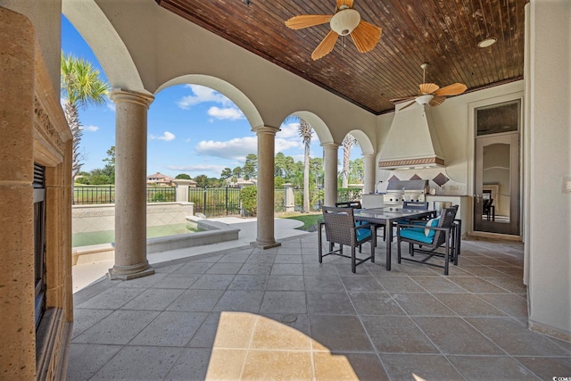 view of patio featuring area for grilling, outdoor dining area, fence, and ceiling fan