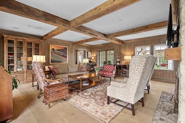 living room with coffered ceiling, beam ceiling, wood walls, and light hardwood / wood-style flooring