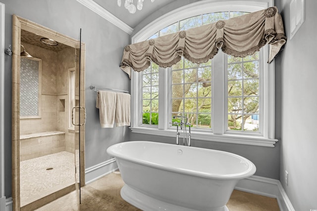 bathroom featuring plenty of natural light, ornamental molding, and separate shower and tub