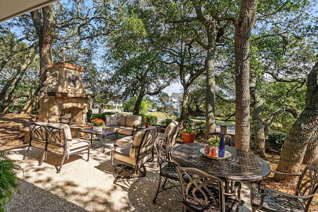 view of patio featuring an outdoor living space with a fireplace