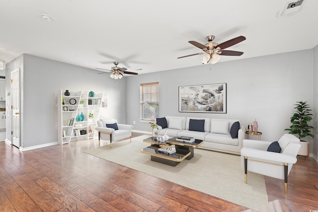 living room featuring dark wood-type flooring and ceiling fan