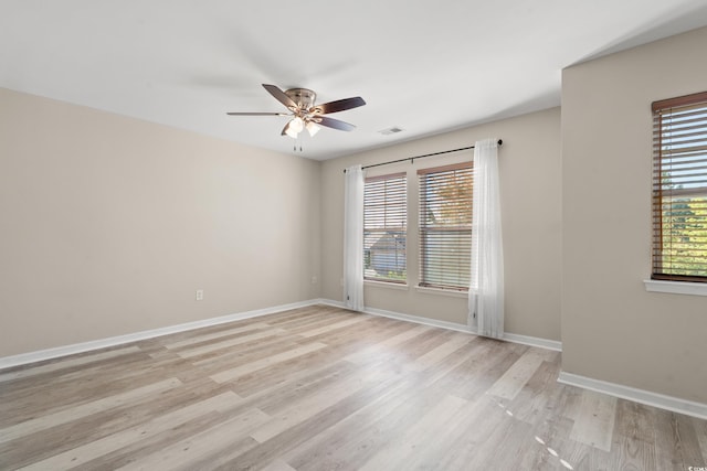 empty room with light hardwood / wood-style flooring and ceiling fan