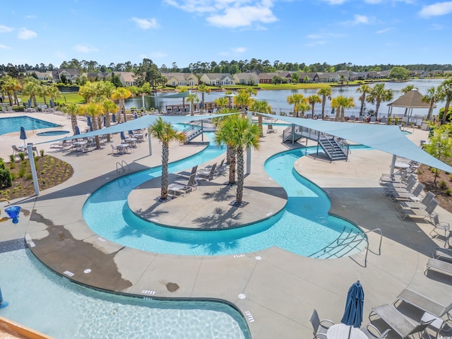 view of pool featuring a patio area and a water view