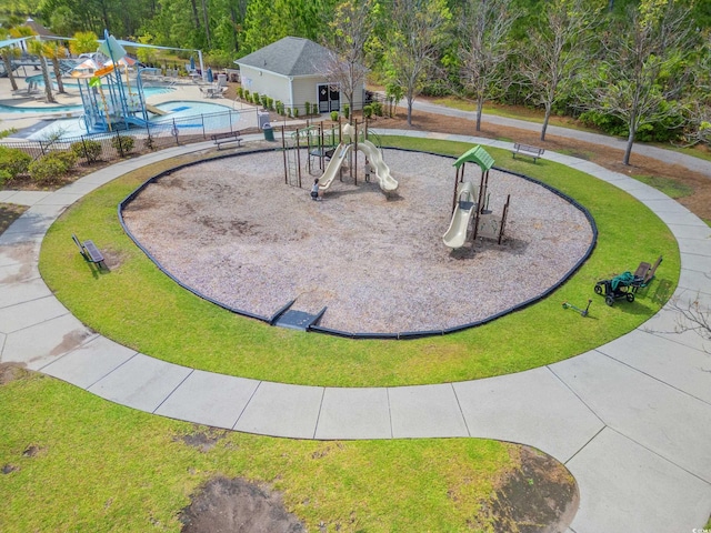 view of home's community with a yard, a playground, and a pool