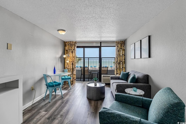 1501 S Ocean Blvd Unit 240, Myrtle Beach, SC 29577 - living room with a textured ceiling, a textured wall, wood finished floors, and floor to ceiling windows