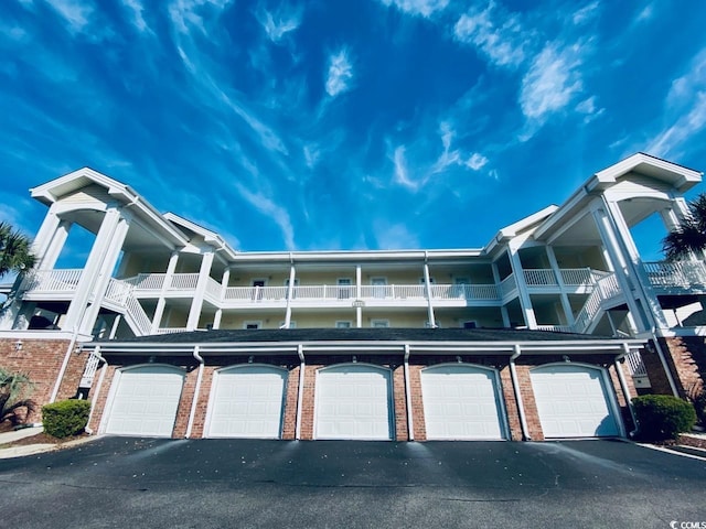 exterior space featuring a balcony and a garage