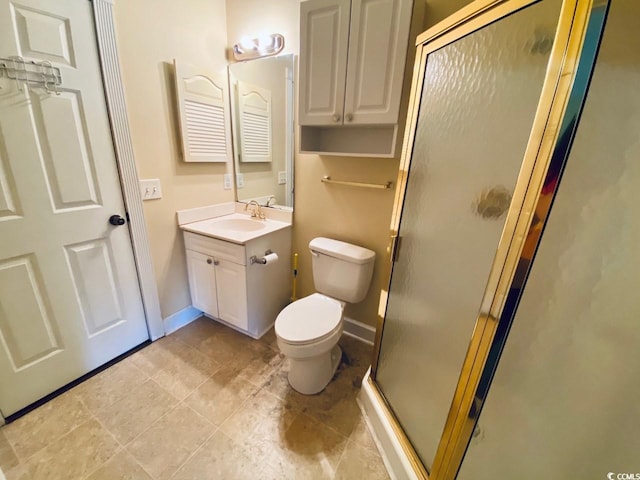 bathroom with vanity, a shower with shower door, and toilet